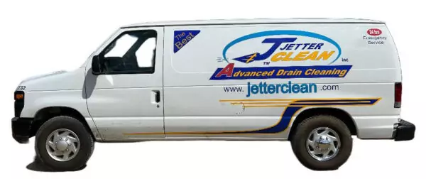 Jetter clean van from the outside, white with Jetter Clean logo on the side. One-ton van isn't very tall